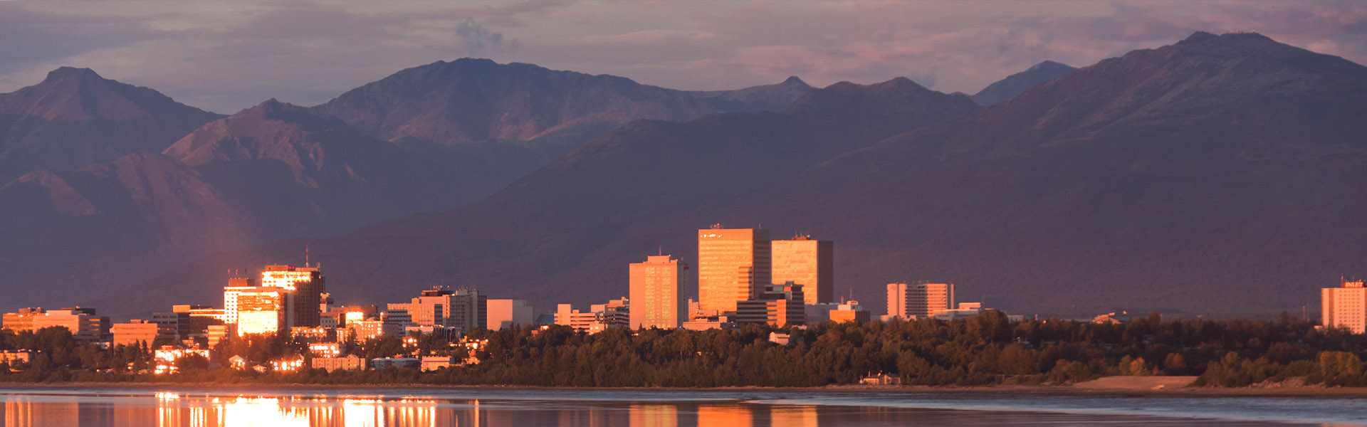 Neon color image of a band playing and people singing along