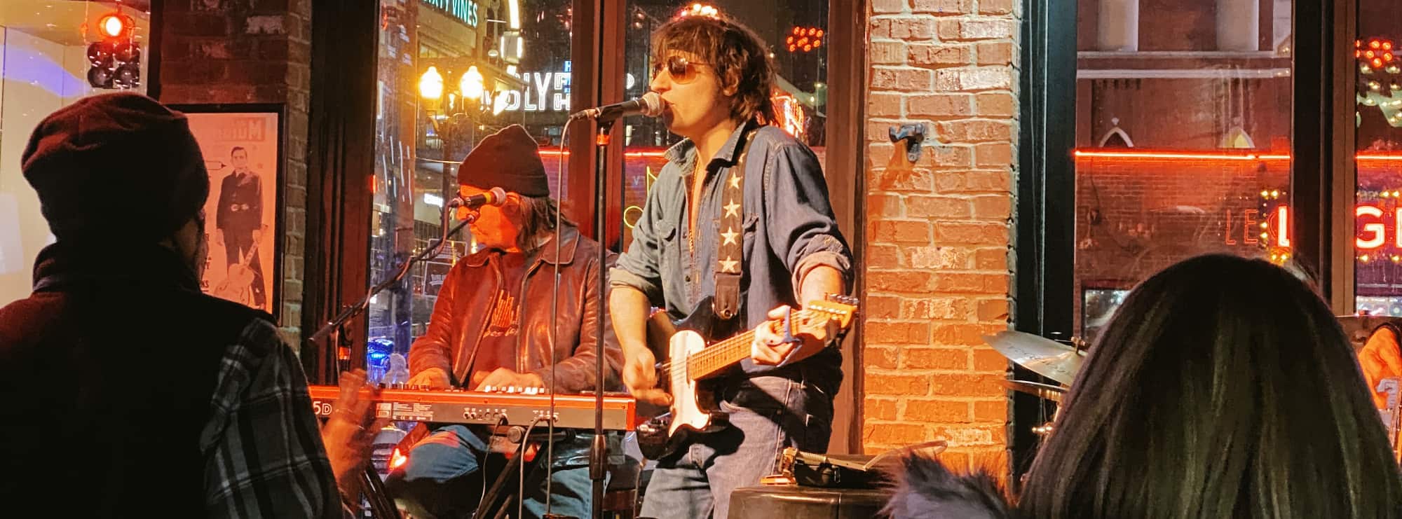 bar singer on guitar in Anchorage