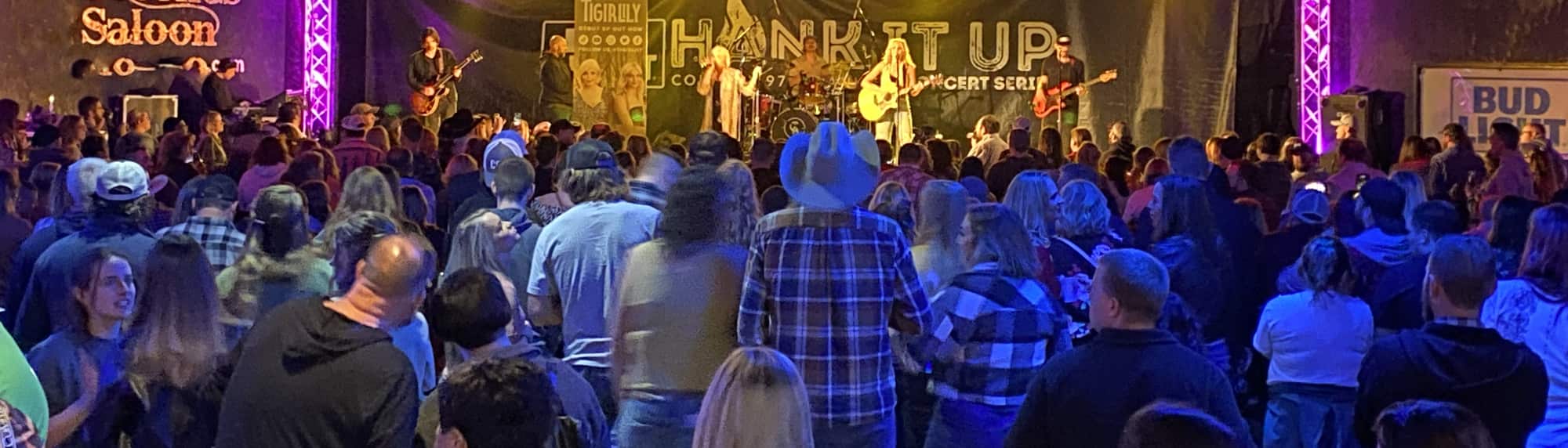 country concert with fans wearing cowboy hats Anchorage